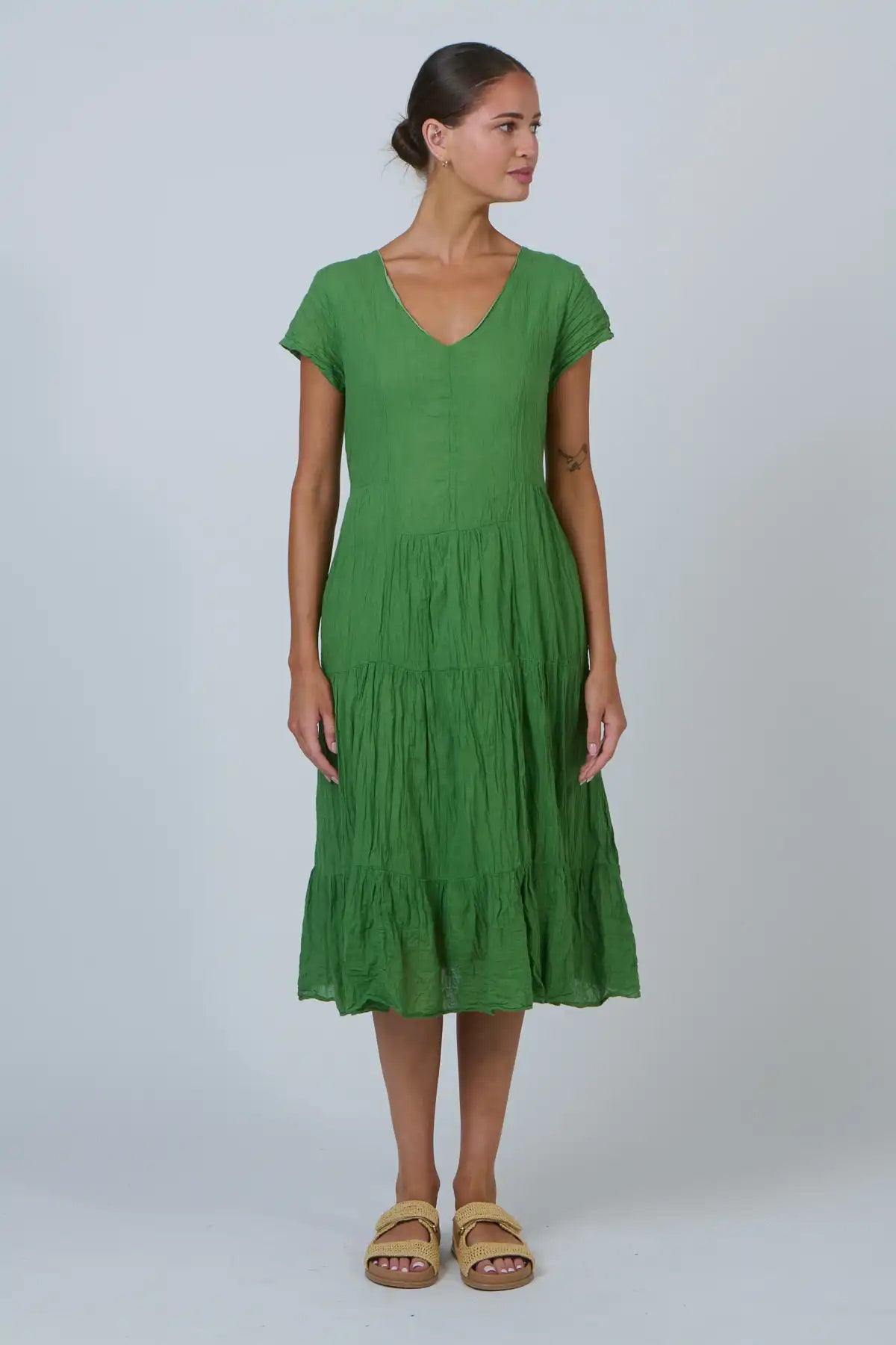 Woman wearing a green dress against a white background