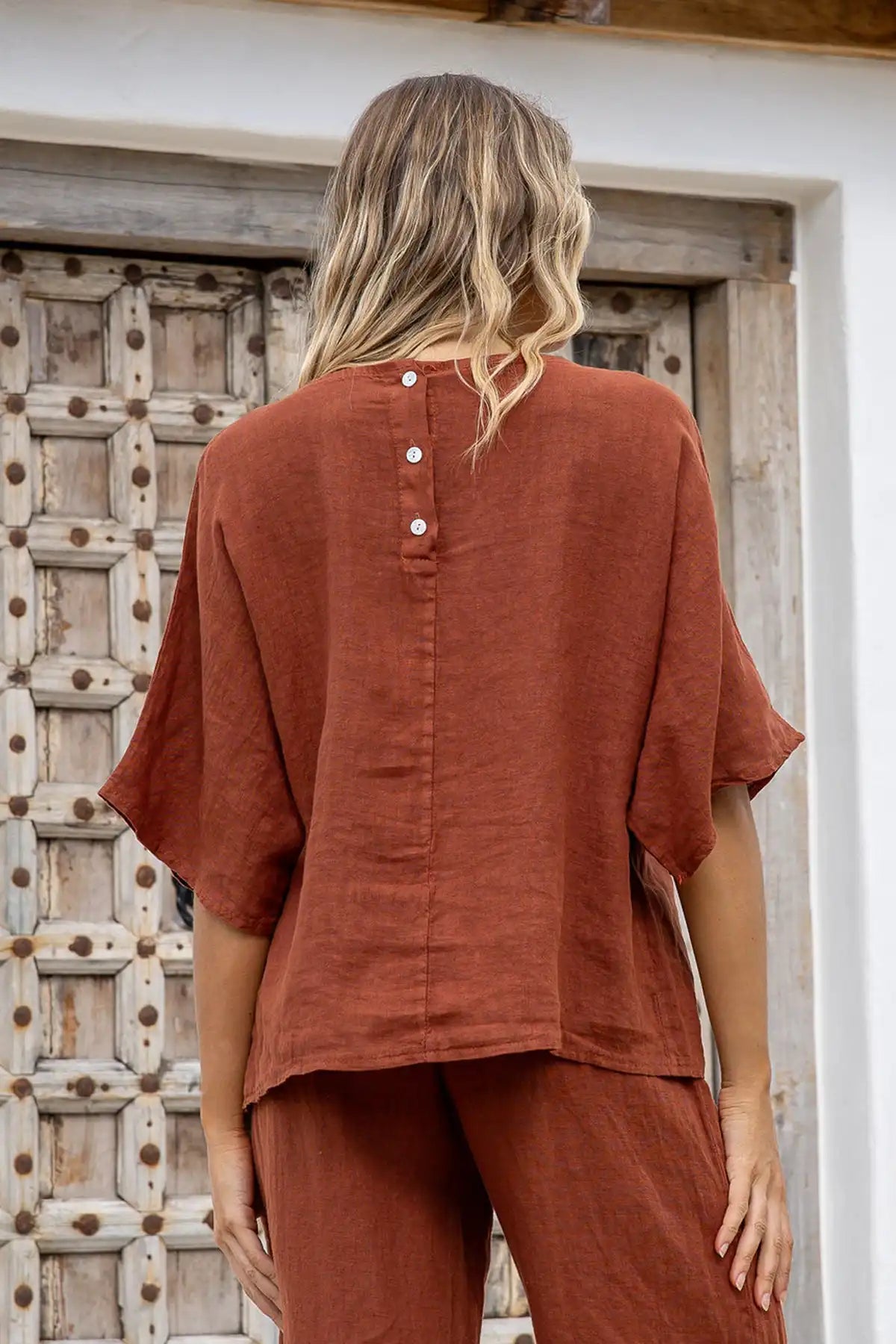 Back view of terracotta linen top with three-button closure