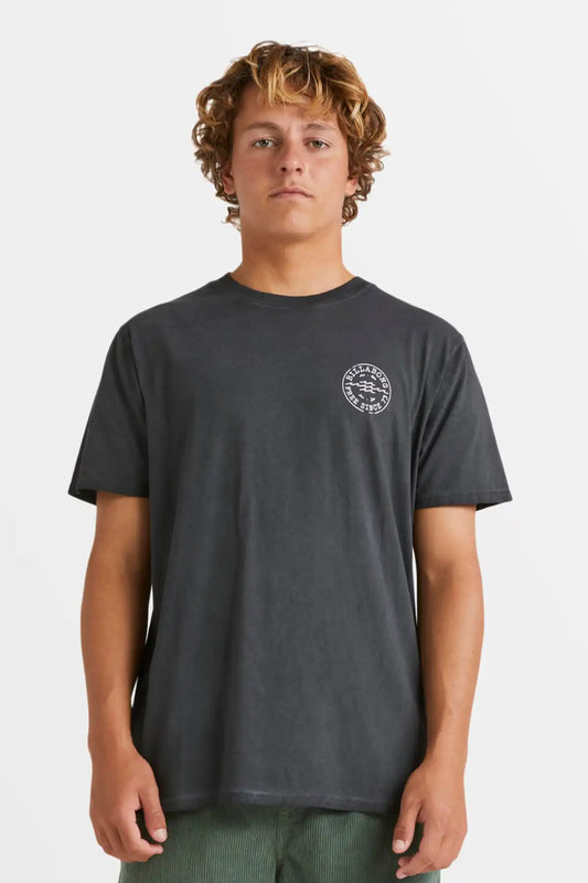 Person wearing a dark gray t-shirt with a logo on a white background