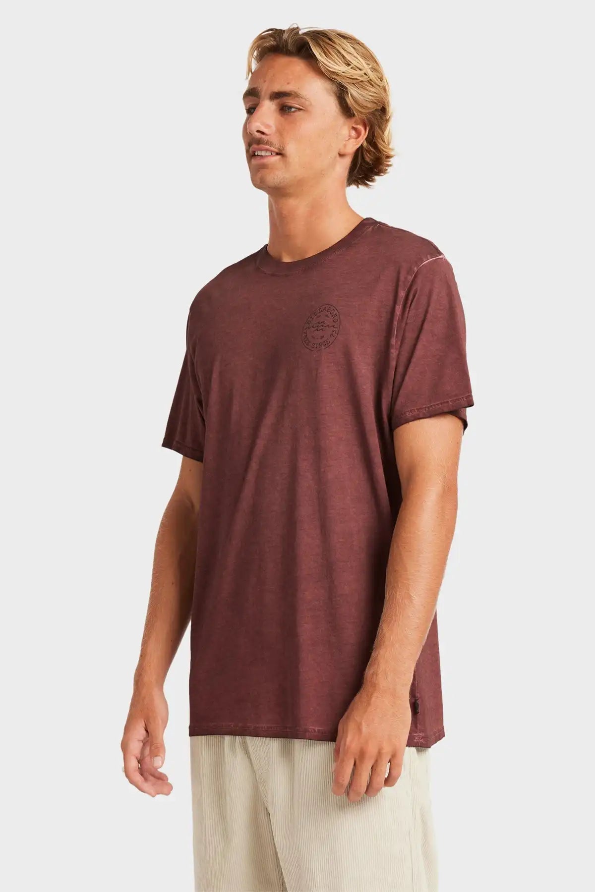 Man wearing a maroon t-shirt with a logo on a white background