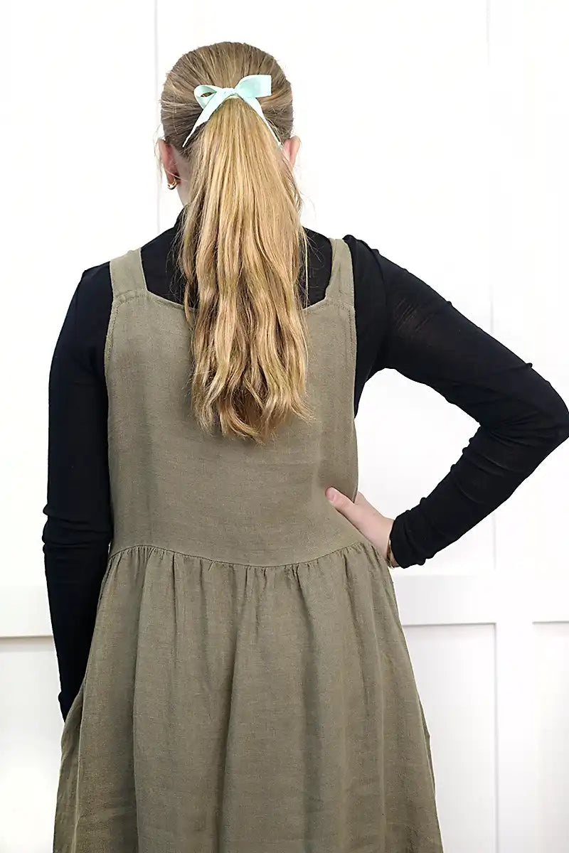 Chille Merino Whisper Top back view in black under olive pinafore dress