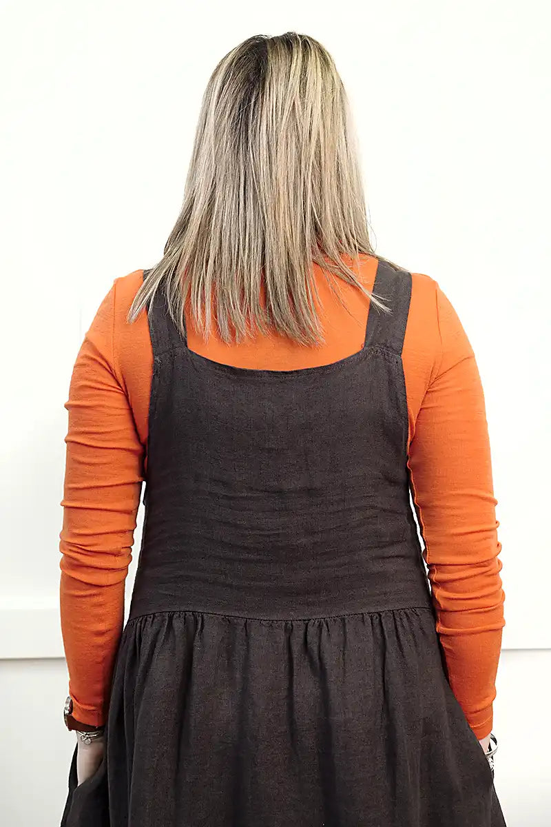 Chille Merino Whisper Top in orange under chocolate sofia pinafore dress back view