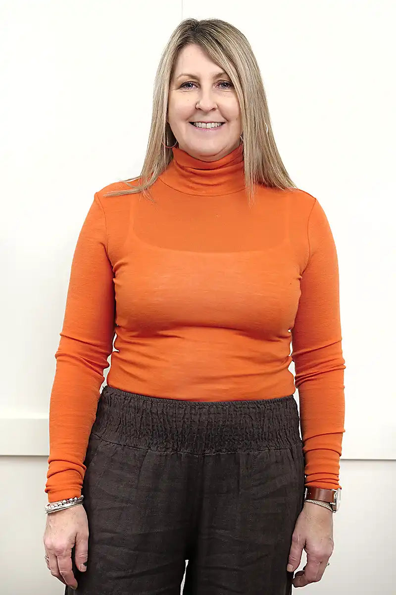 Chille Merino Whisper Top in orange front view tucked in