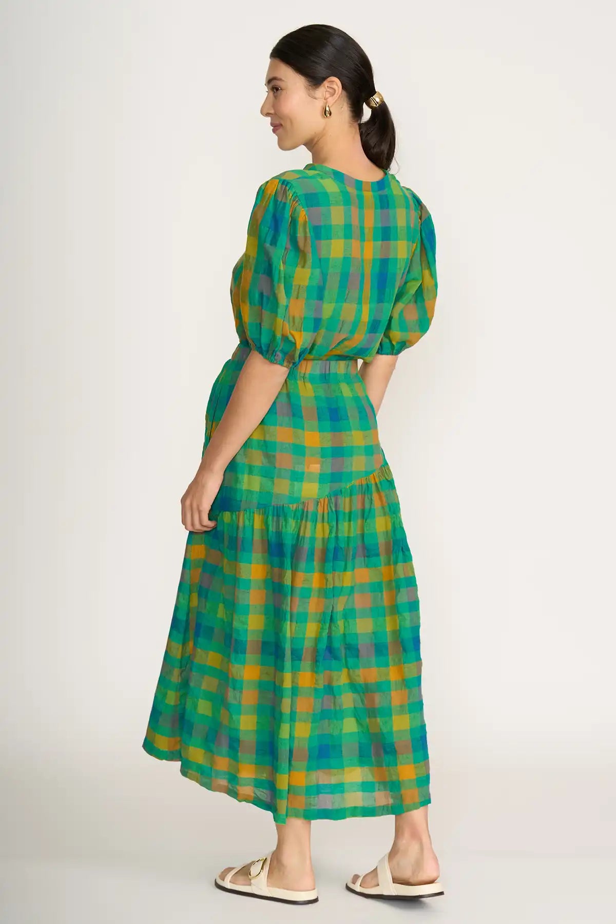 Woman wearing a Foil Checkmate Cotton Linen Skirt in Greencheck on a white background back view