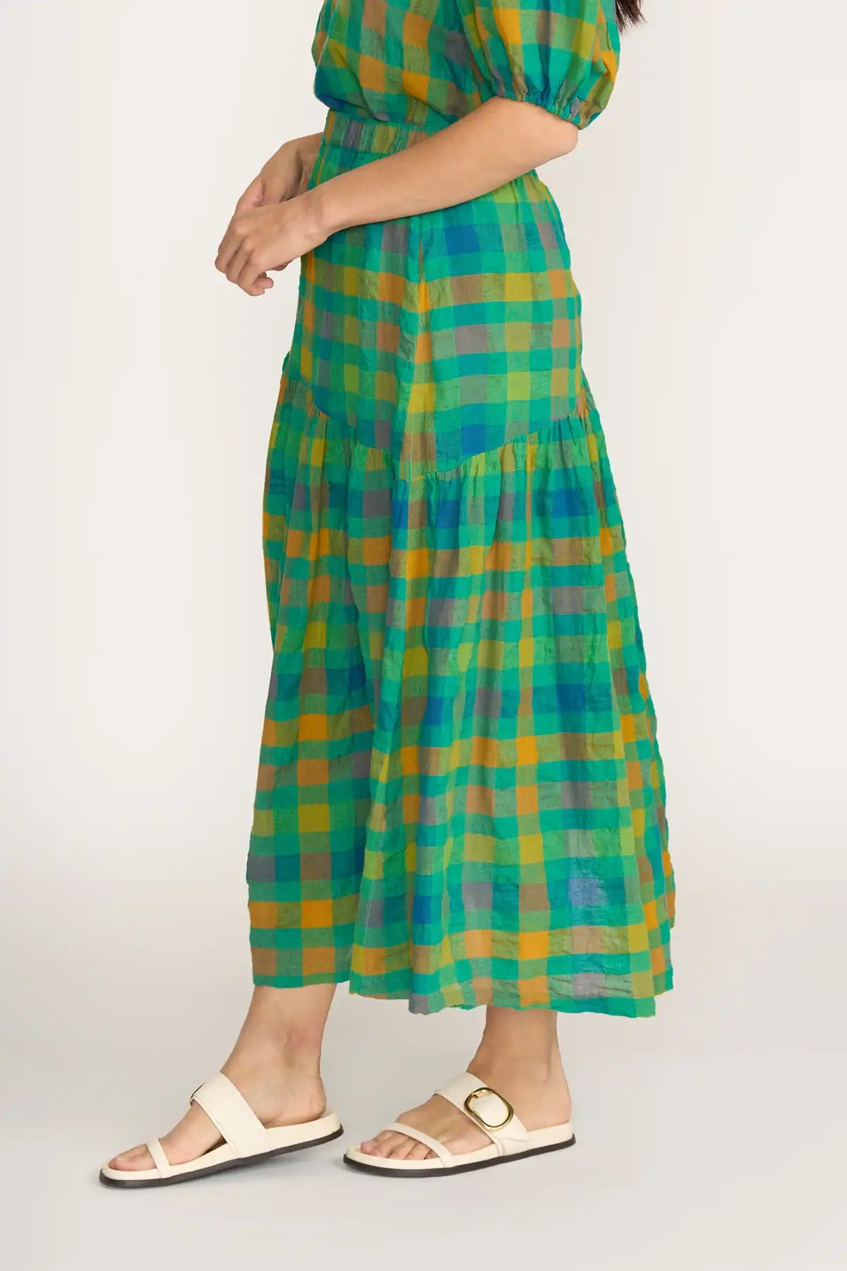 Person wearing aFoil Checkmate Cotton Linen Skirt in Greencheck on a white background side view