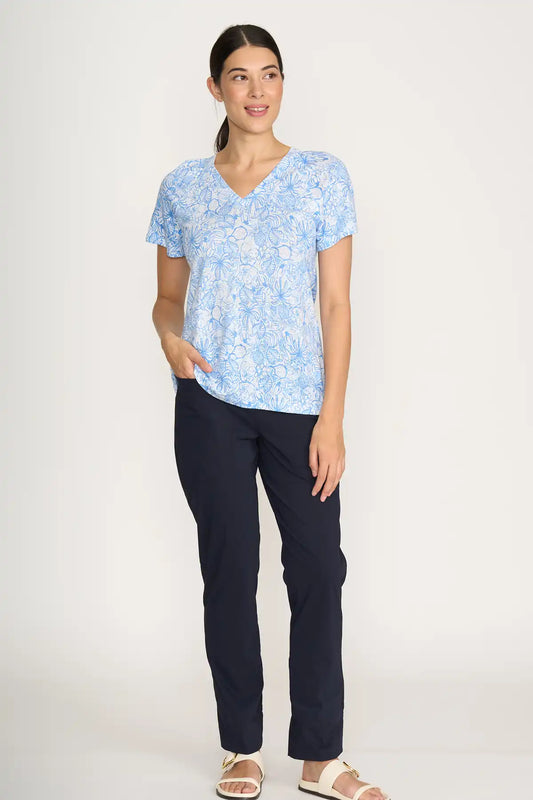 Woman wearing a light blue floral top and Foil Gemini Pant in True Navy on a white background front view