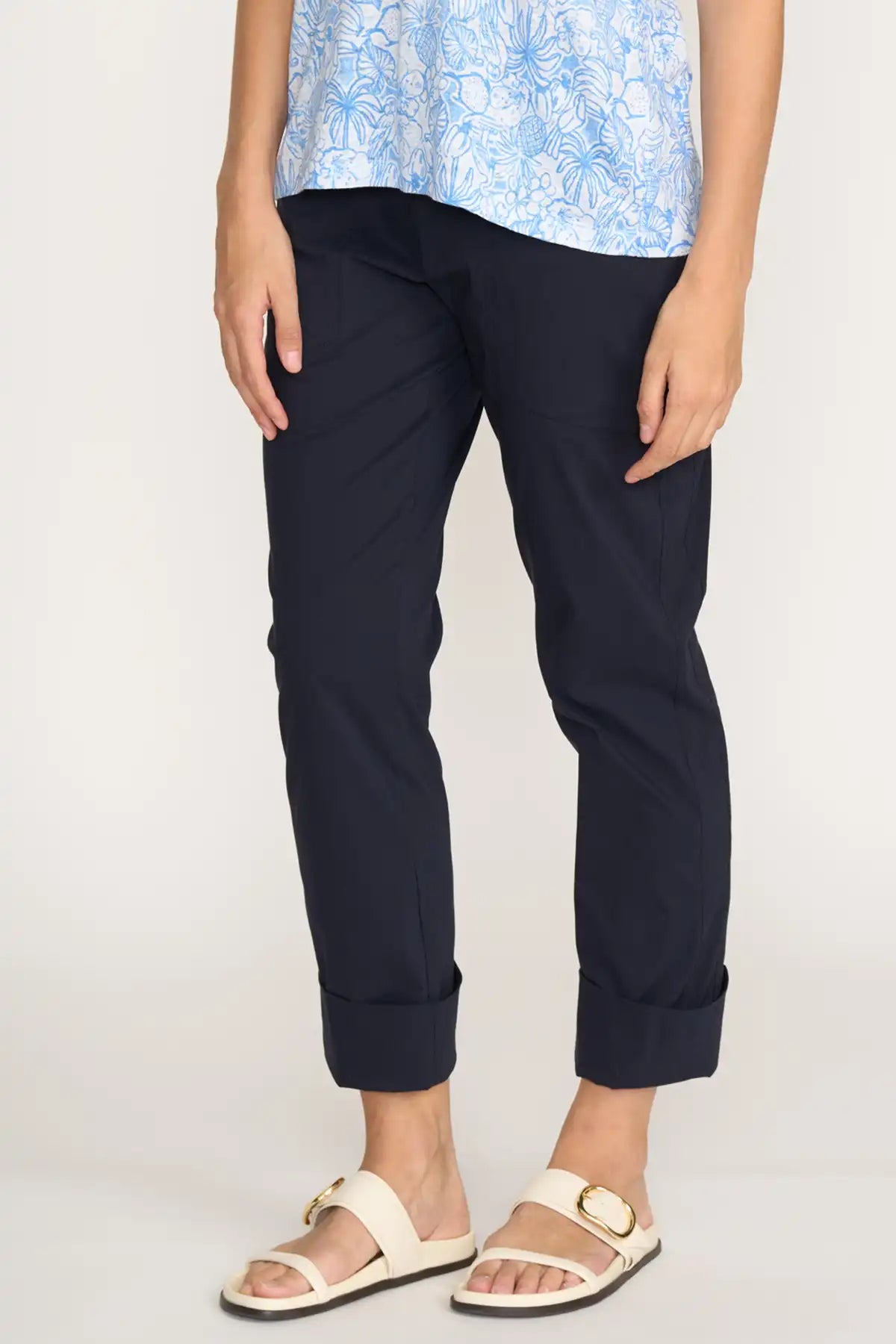 Person wearing Foil Gemini Pant in True Navy and a light blue floral top on a white background side detailed view
