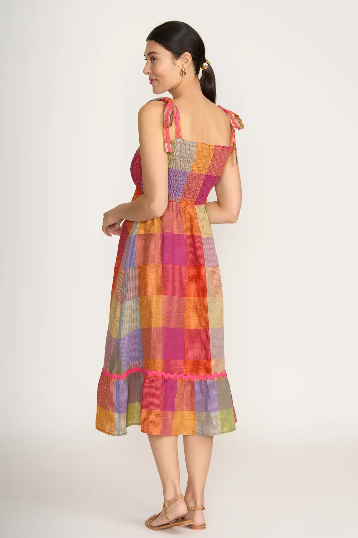 Woman wearing a Foil Linen Moral fibre Dress in Fiesta Check on a white background back view