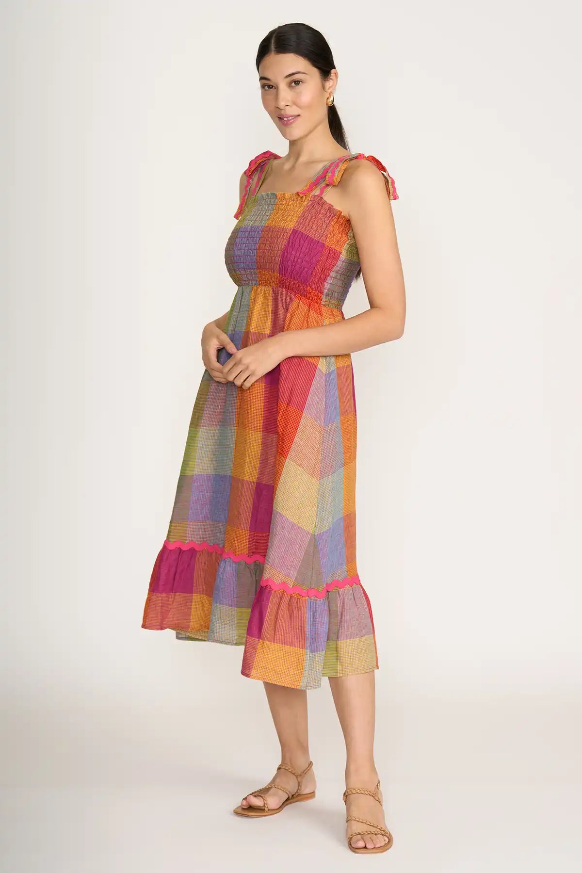 Woman wearing a Foil Linen Moral fibre Dress in Fiesta Check on a white background side view