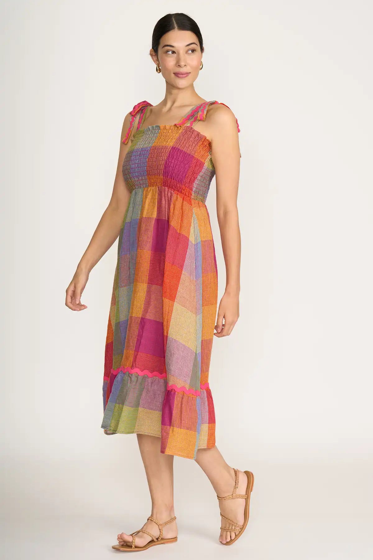 Woman wearing a Foil Linen Moral fibre Dress in Fiesta Check side view on a white background