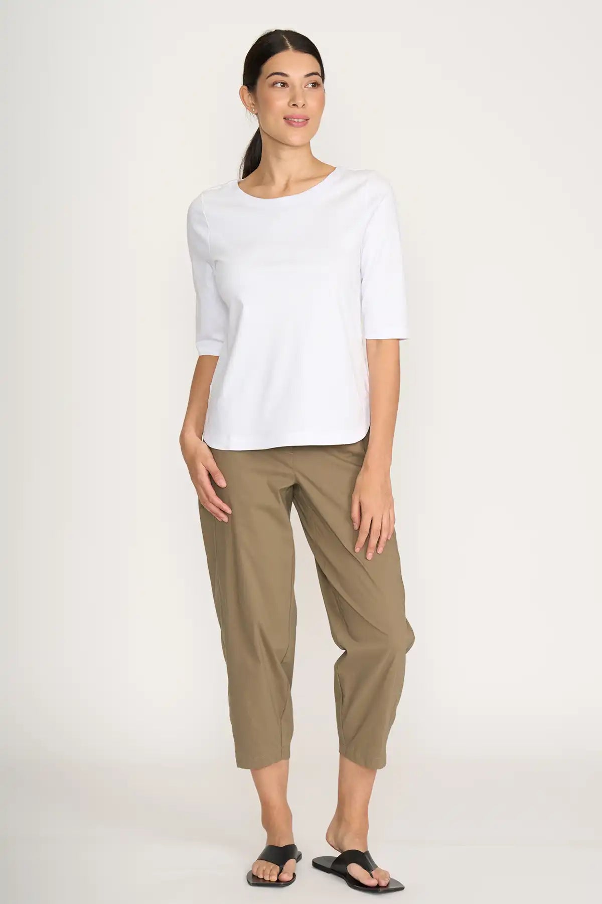Woman wearing a white top and Foil Pump it Up Pant in Dune on a white background