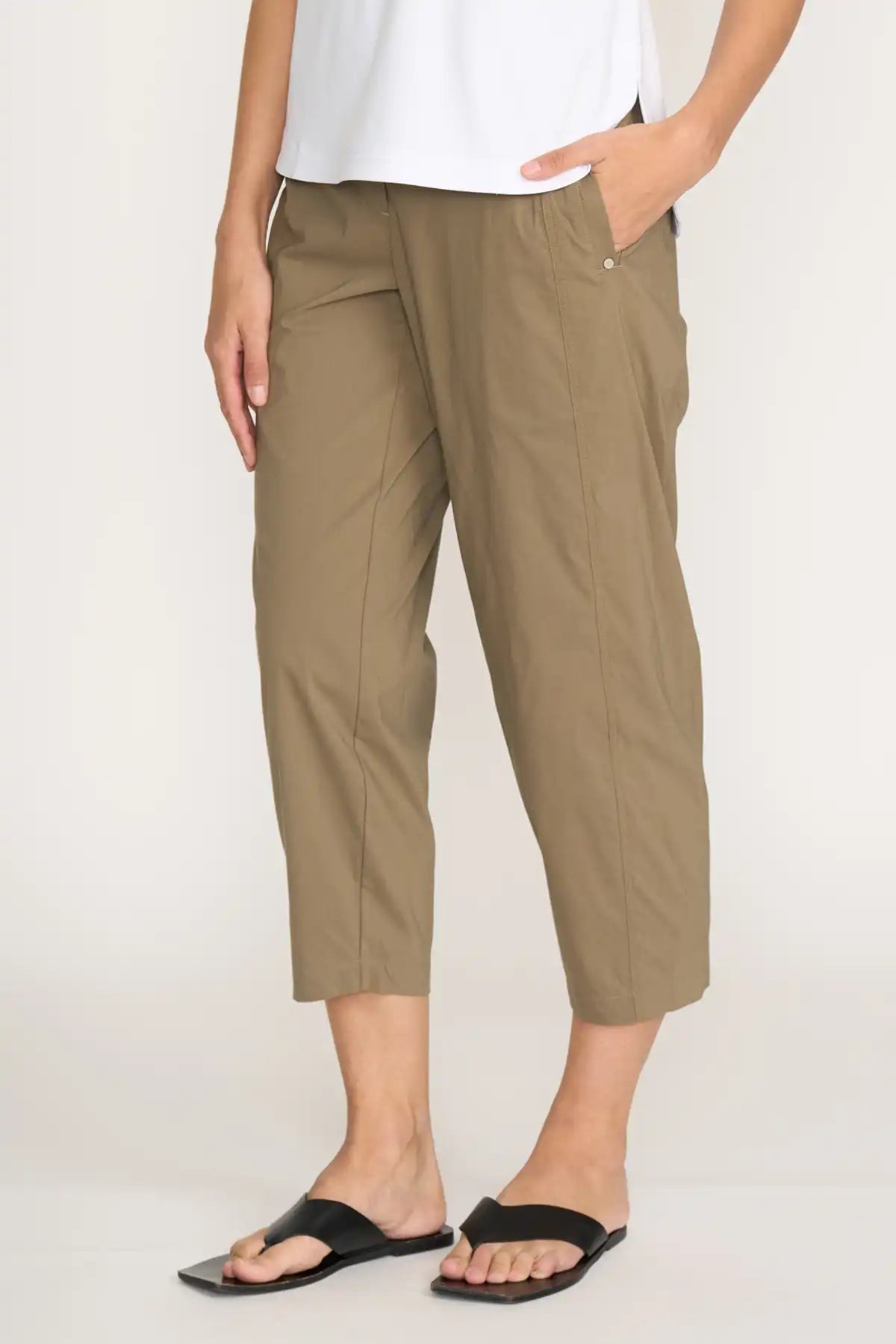 Person wearing Foil Pump it Up Pant in Dune and black sandals on a plain background detailed side view