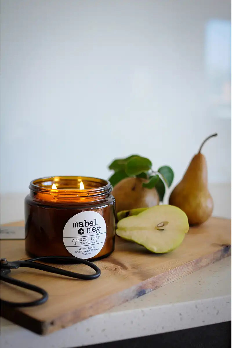 Soy candle - french pear and vanilla on a bench with pears