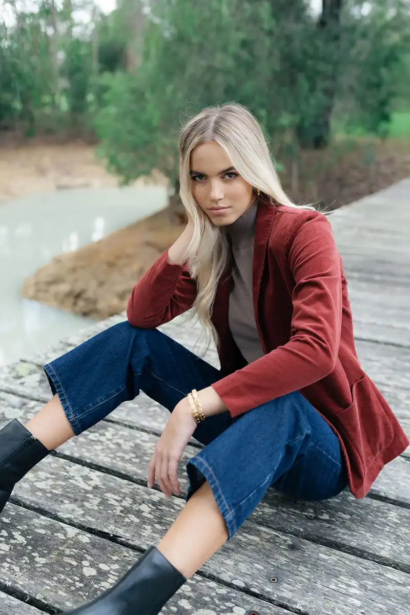 Humidity Blondie Corduroy Jacket in Rust feature image sitting on the dock