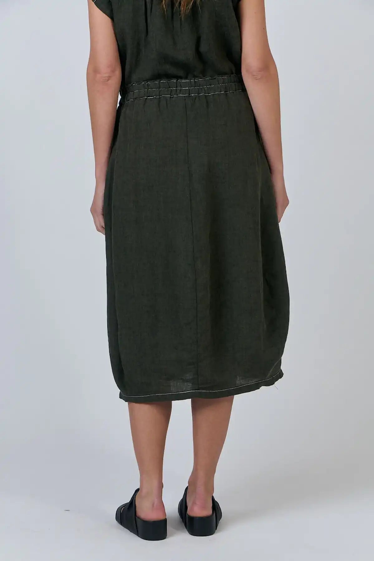 Person wearing a Licorice Linen Skirt on a white background