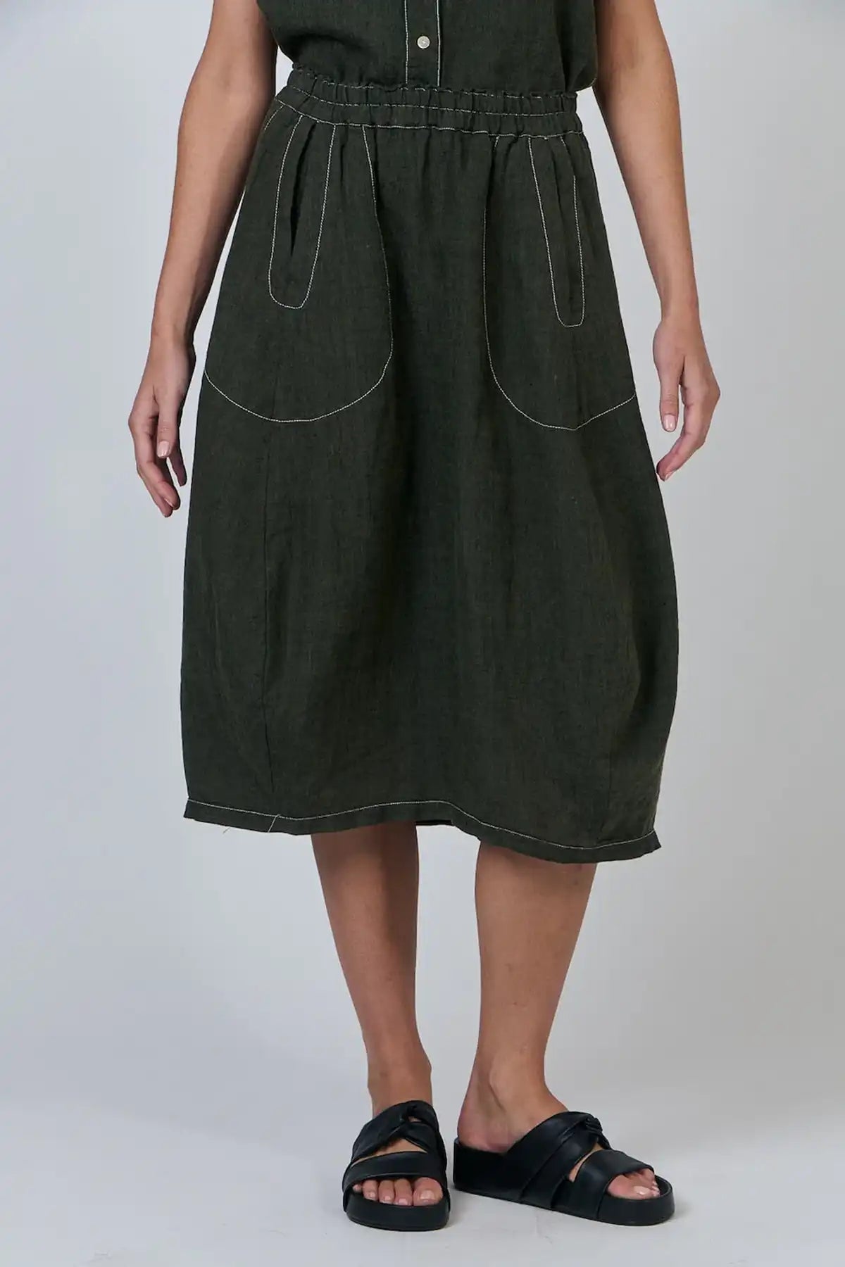 Person wearing a Licorice Linen Skirt on a plain background