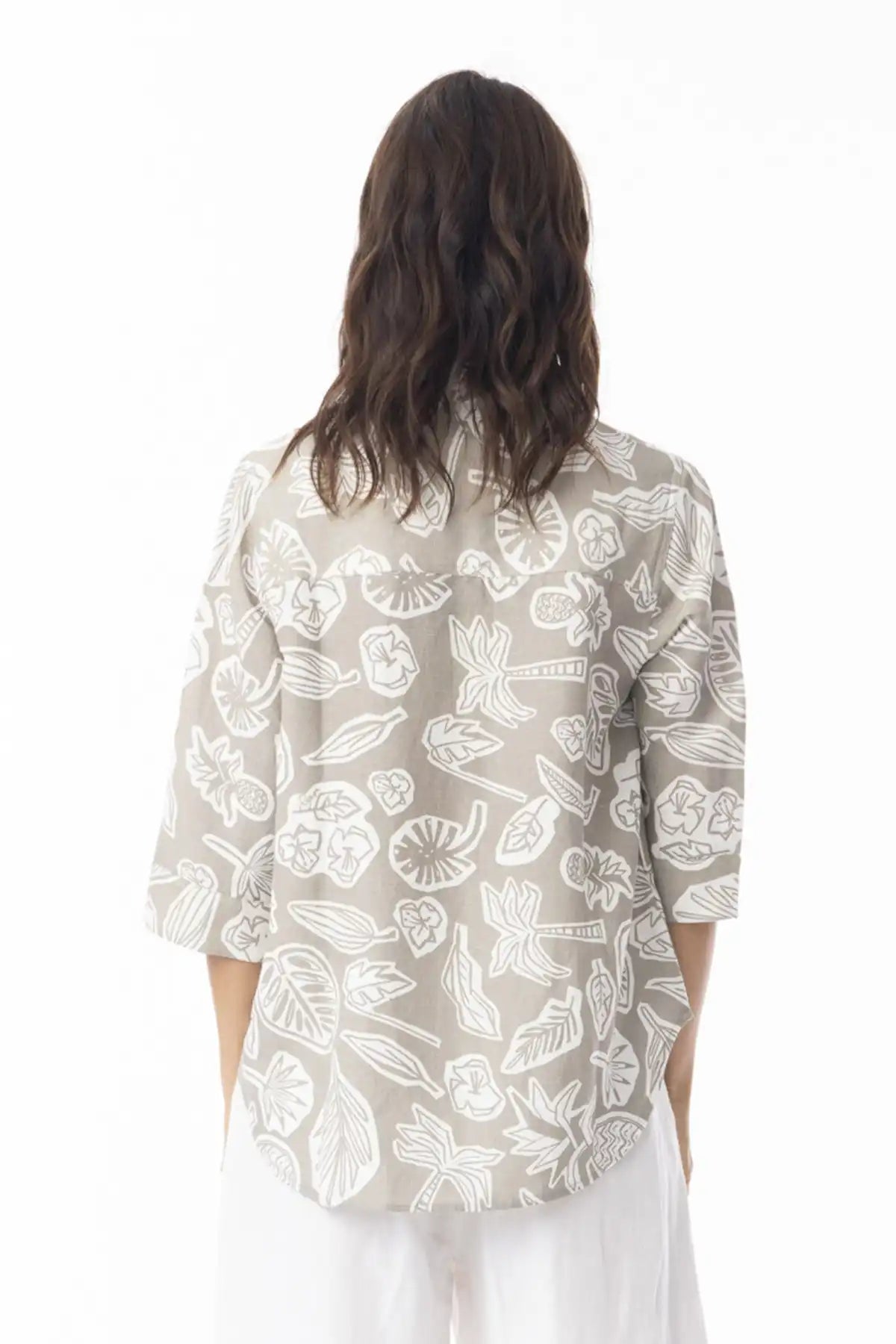 Person wearing a Orientique Escape Linen Boxy Collar Shirt in sand print standing back on against a white background