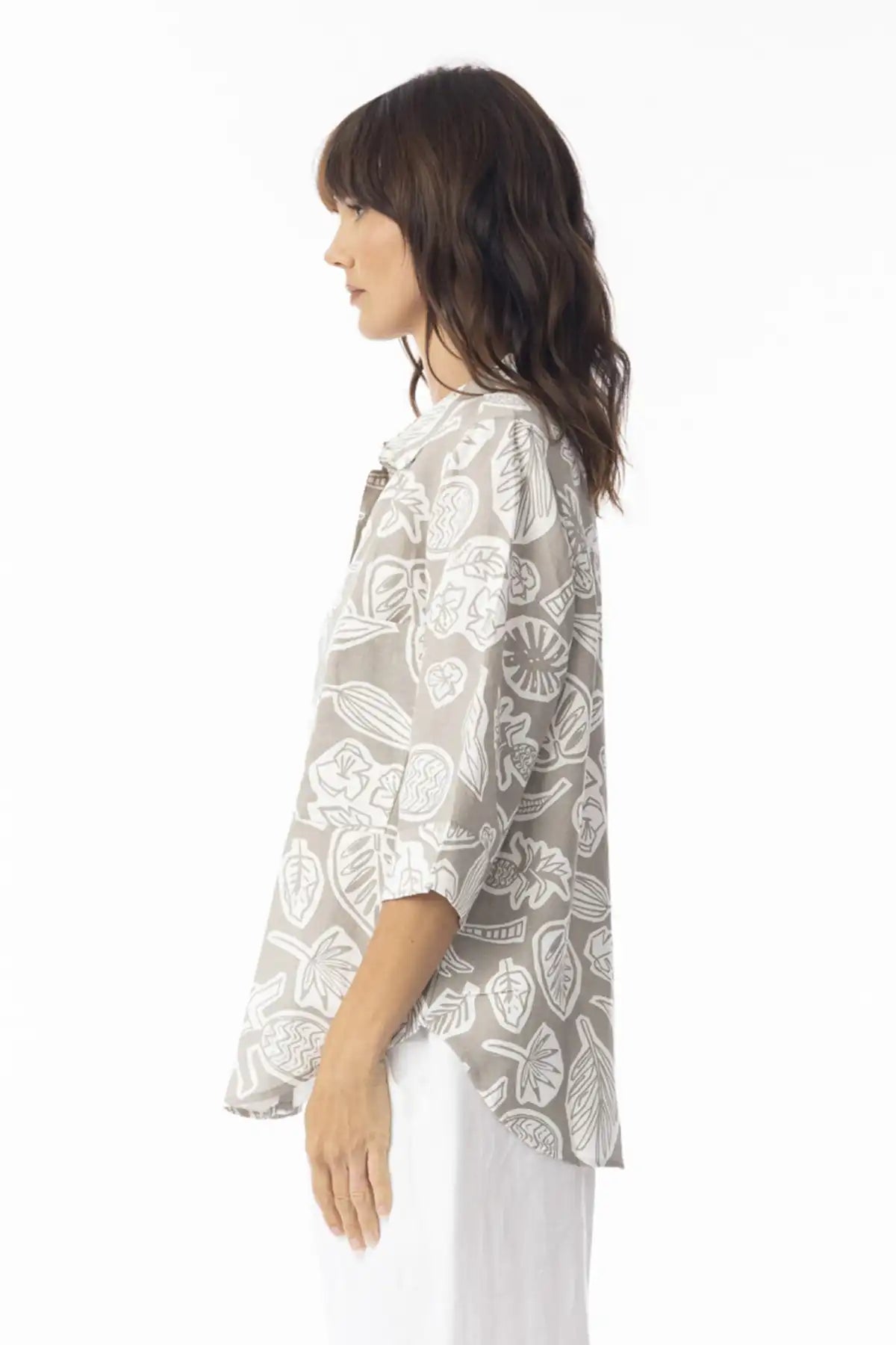 Woman wearing a Orientique Escape Linen Boxy Collar Shirt in sand print on a white background