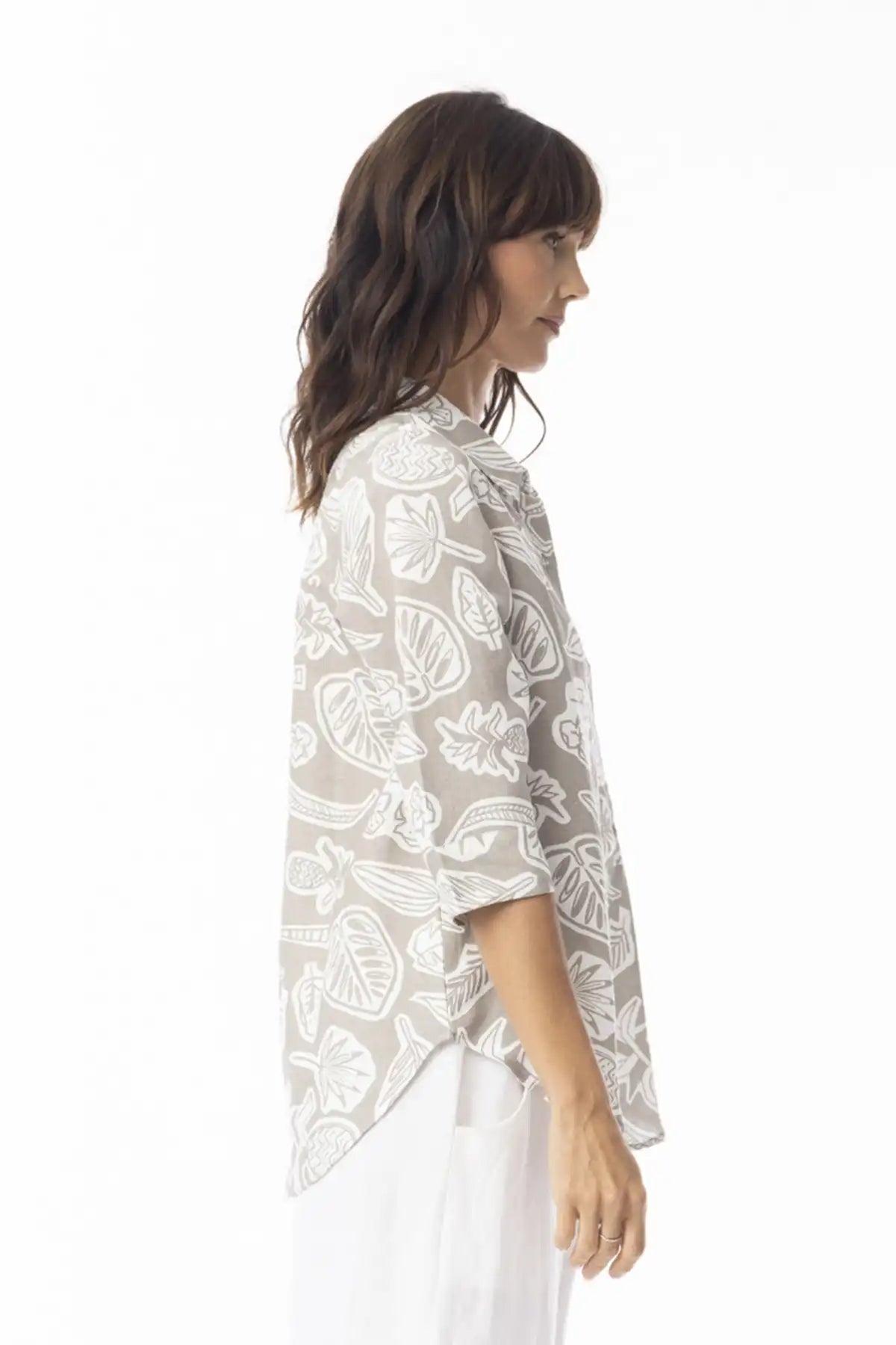 Woman wearing a Orientique Escape Linen Boxy Collar Shirt in sand print with long sleeves on a white background