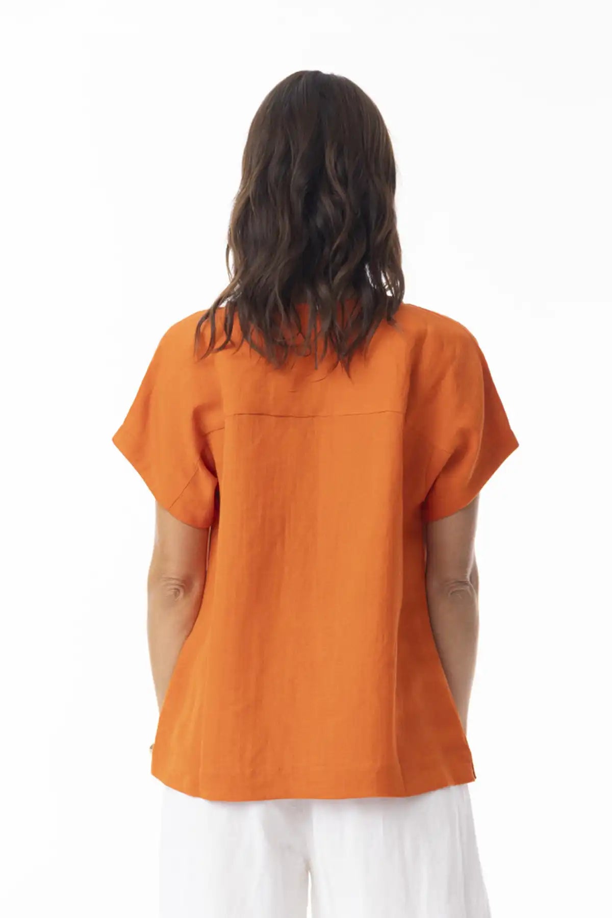 Person wearing an Orientique Escape Linen Solid Boxy Top in Mandarin on a white background back on