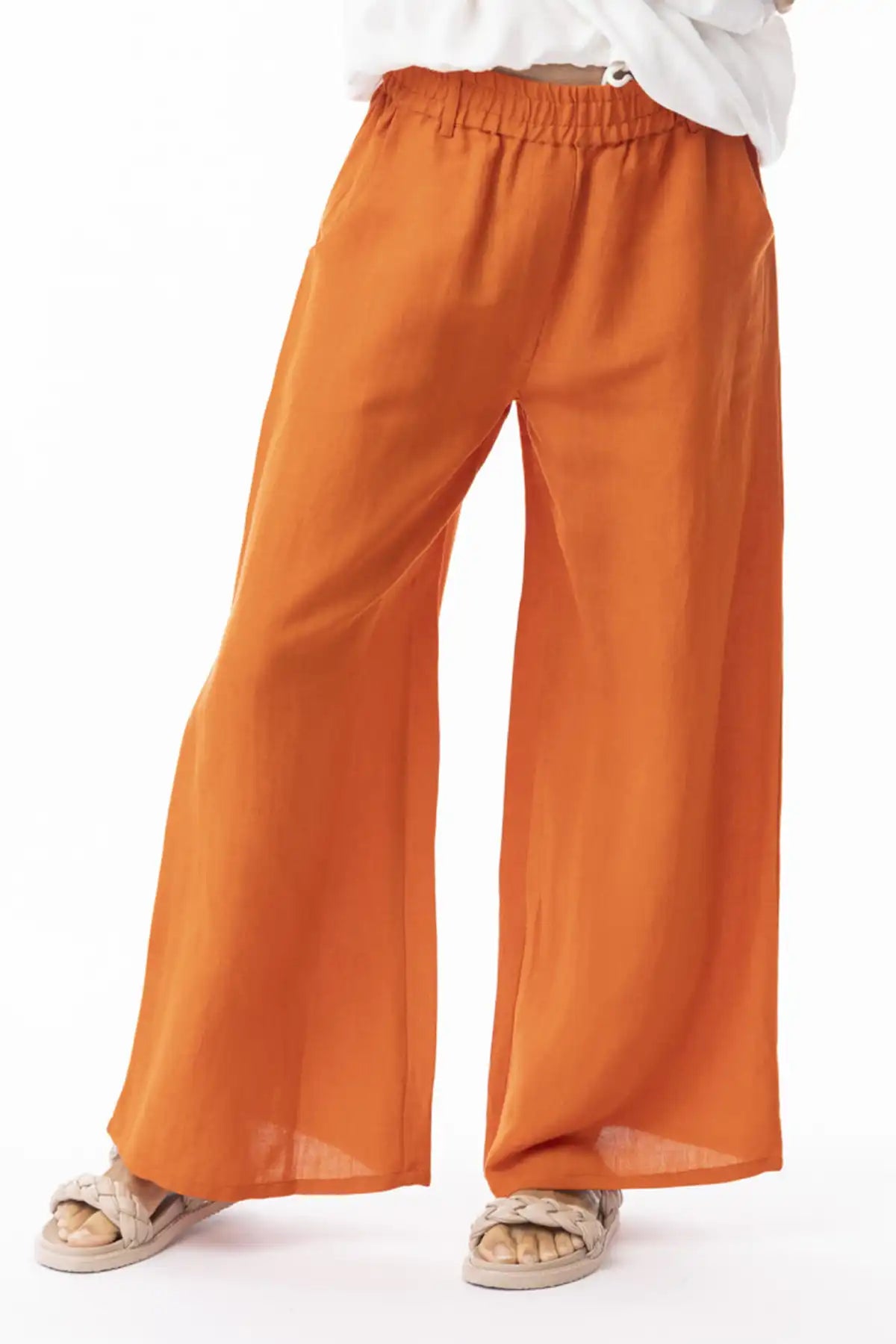 Orientique Escape Linen Wide Leg Pants in Mandarin worn with a white top on a white background
