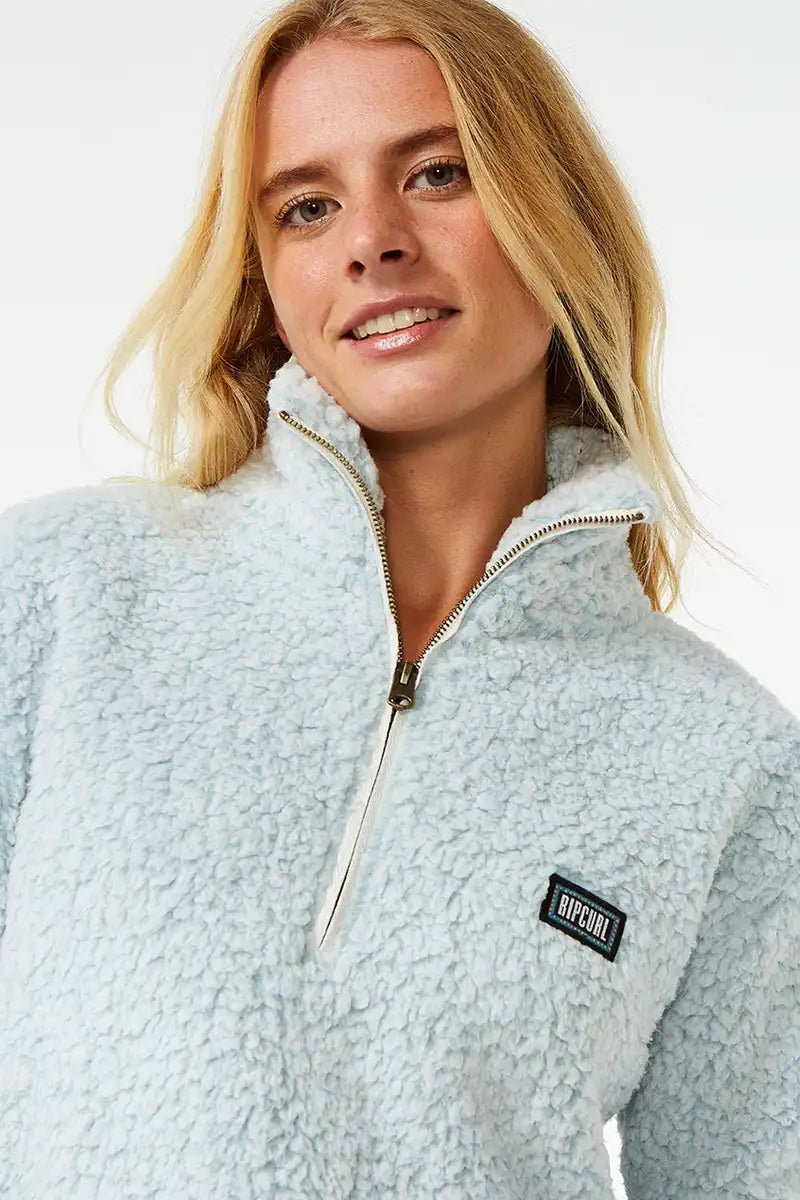 Rip Curl Dark n Stormy 1/4 Zip Crew Jumper in Blue front detailed view of the zip and logo badge