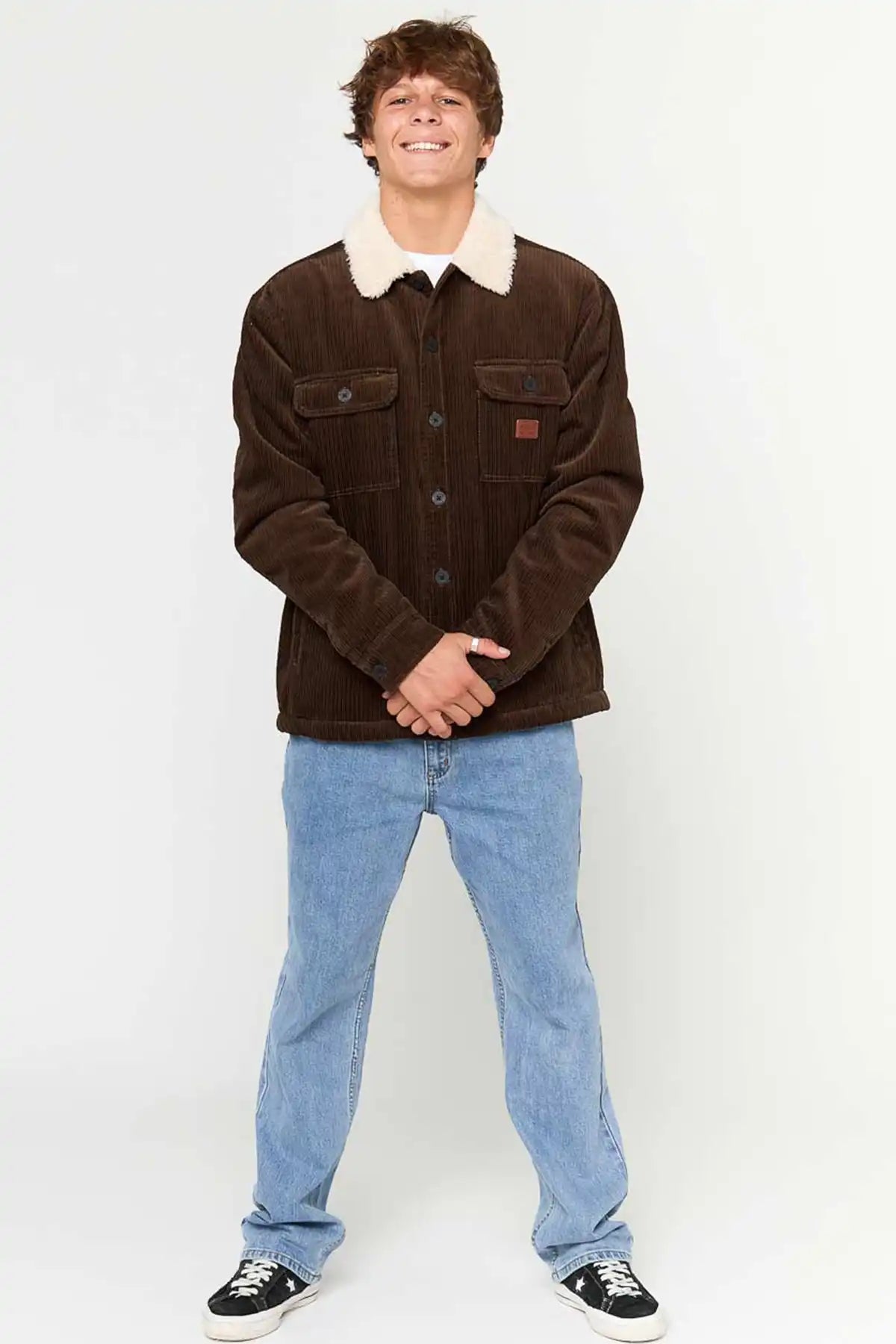 Person wearing Rip Curl Men's Bells Sherpa Jacket in Coffee with a white collar and blue jeans on a white background front full model view