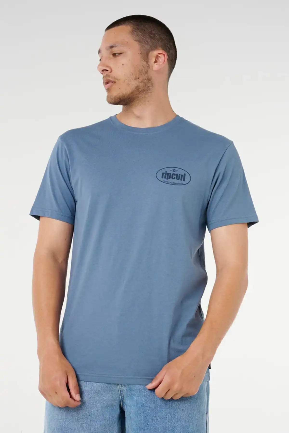 Man wearing a blue t-shirt with a Rip Curl logo on a white background
