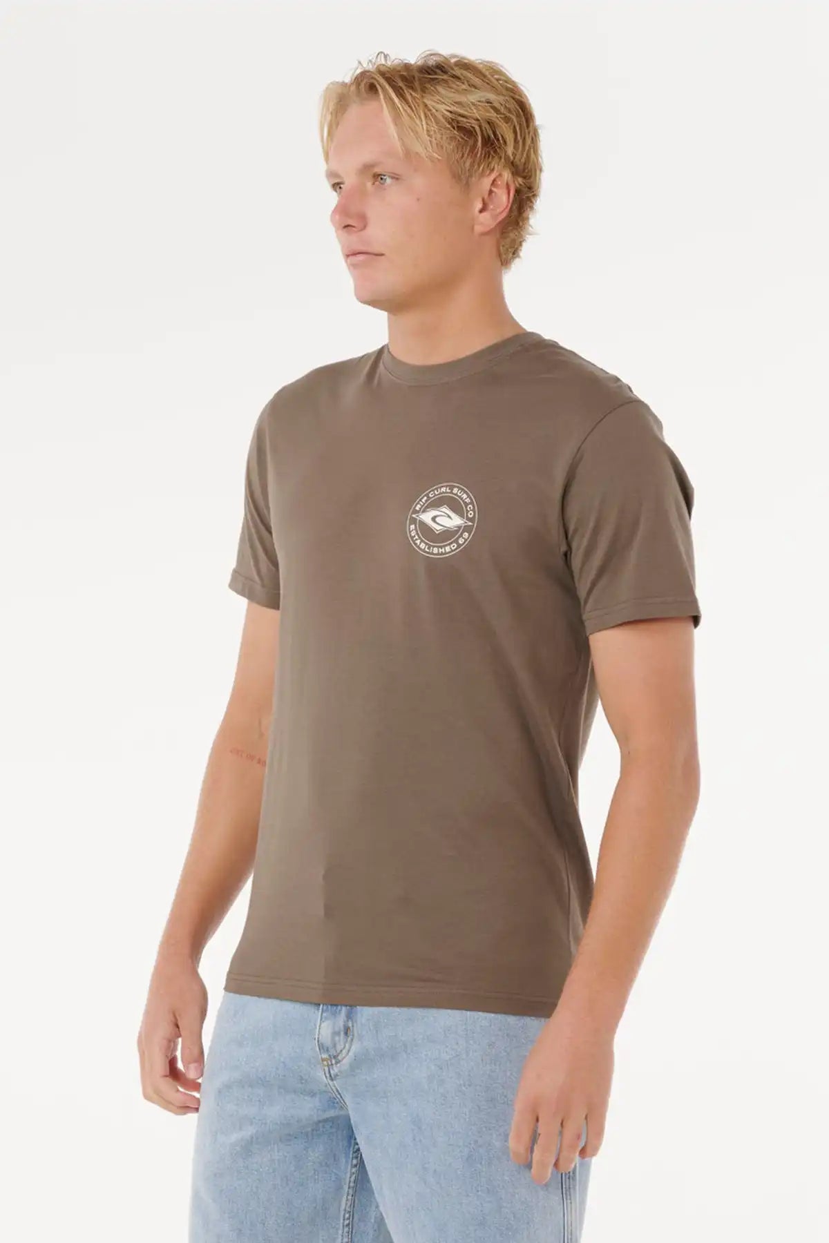 Man wearing a brown t-shirt with a logo on a white background side view