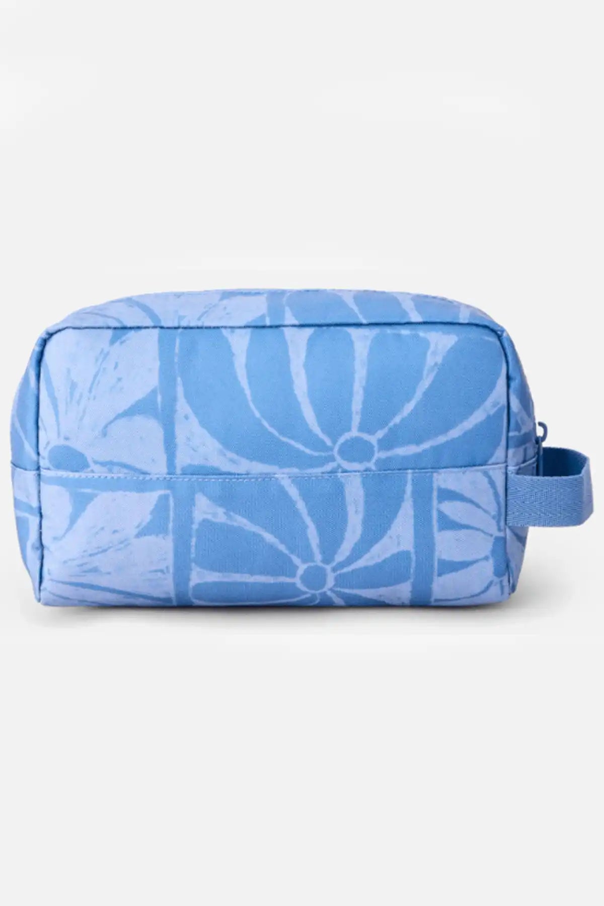 Blue toiletry bag with white floral pattern on a light gray background