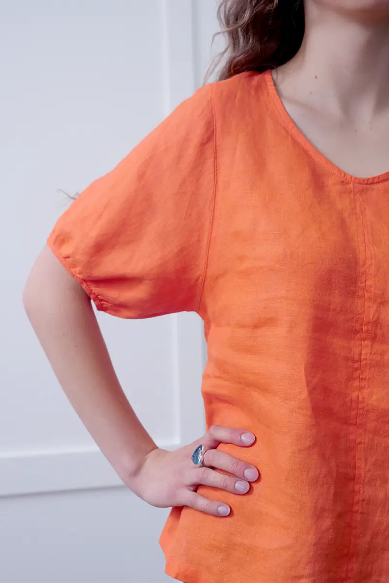 Sleeve and neck detail on the See Saw Linen V-Neck Swing Top in Sunset