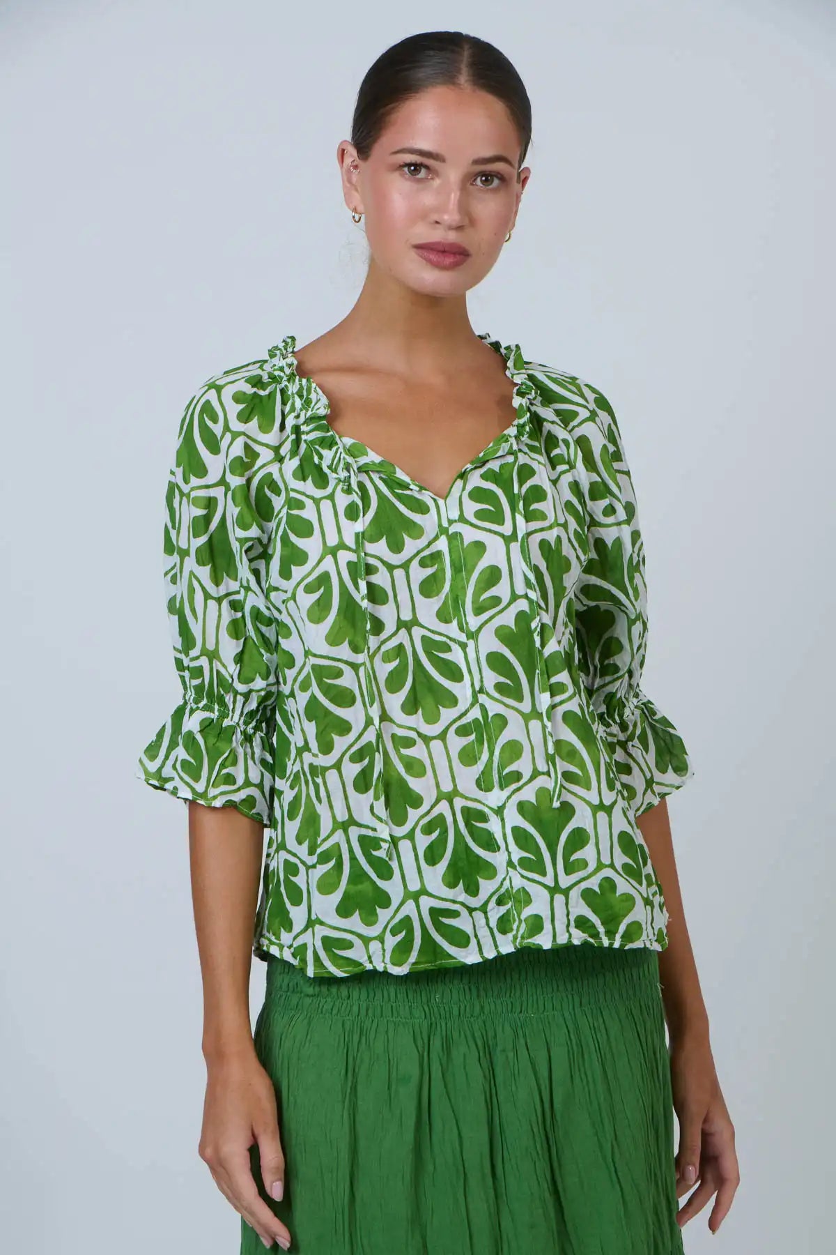 front on view of woman wearing the Summer Garden Crinkle Cotton Top and green skirt