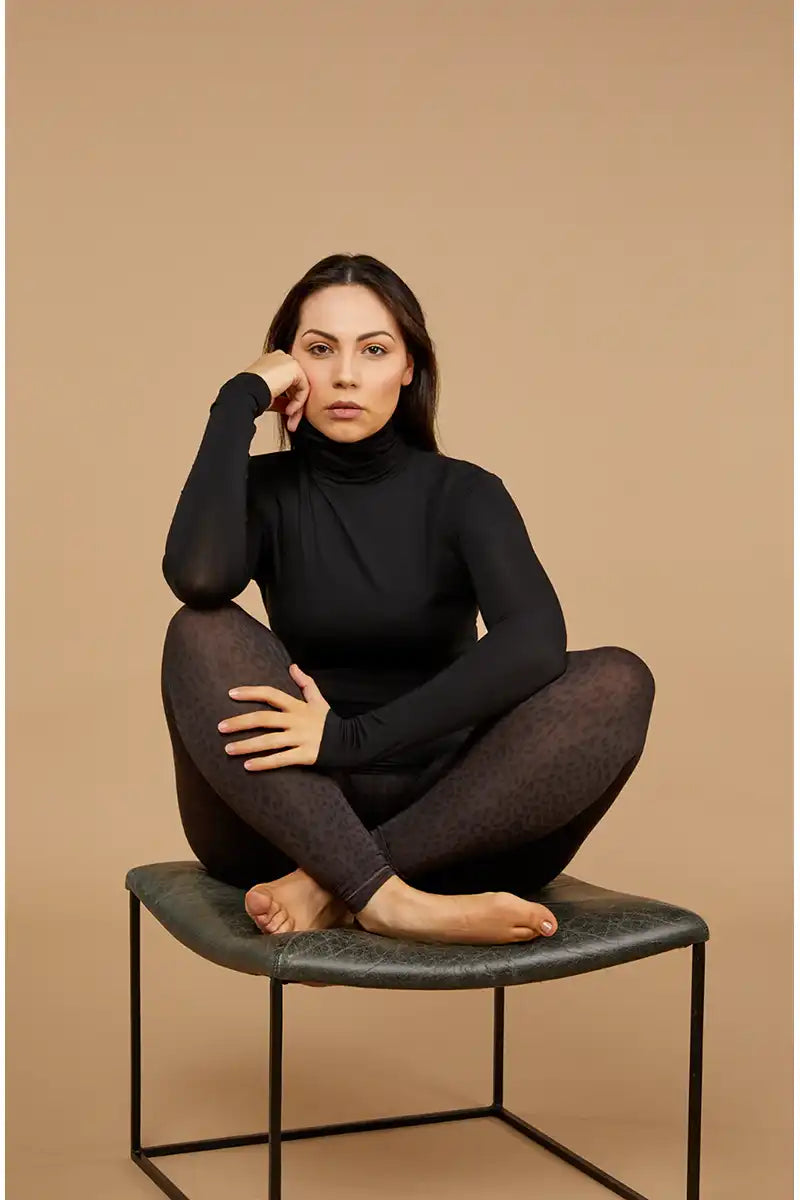 Tani Wild Licorice Micro Modal Stretch Legging model sitting on chair
