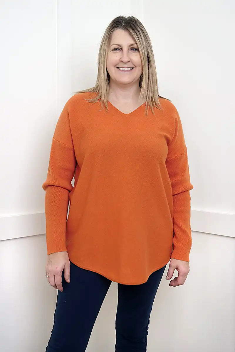 The Rust Glow Lambswool V-Neck Sweater front 3/4 model view
