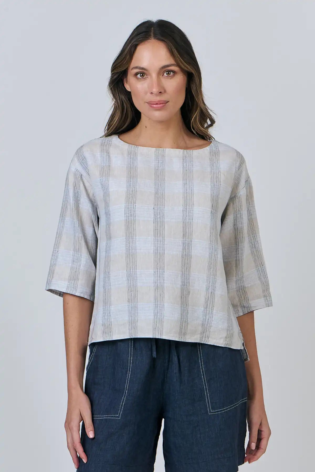 Woman wearing a Mesh Linen Breeze Top and dark pants against a plain background front full view