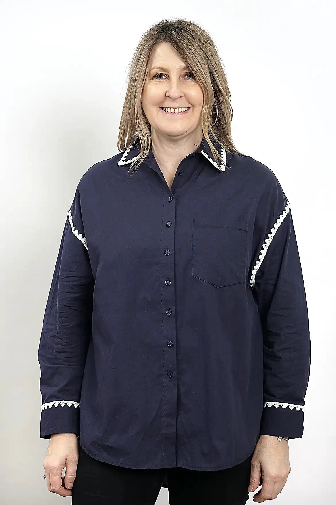 Woman wearing a the Wren Long Sleeve Shirtin Navy with white trim on a plain background