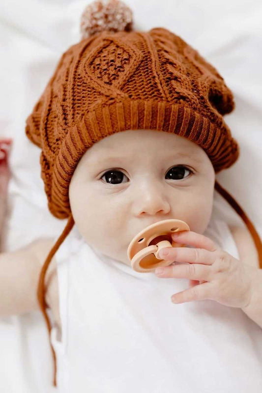 baby wearing rust coloured Luna Bonnet Hat from Di Lusso