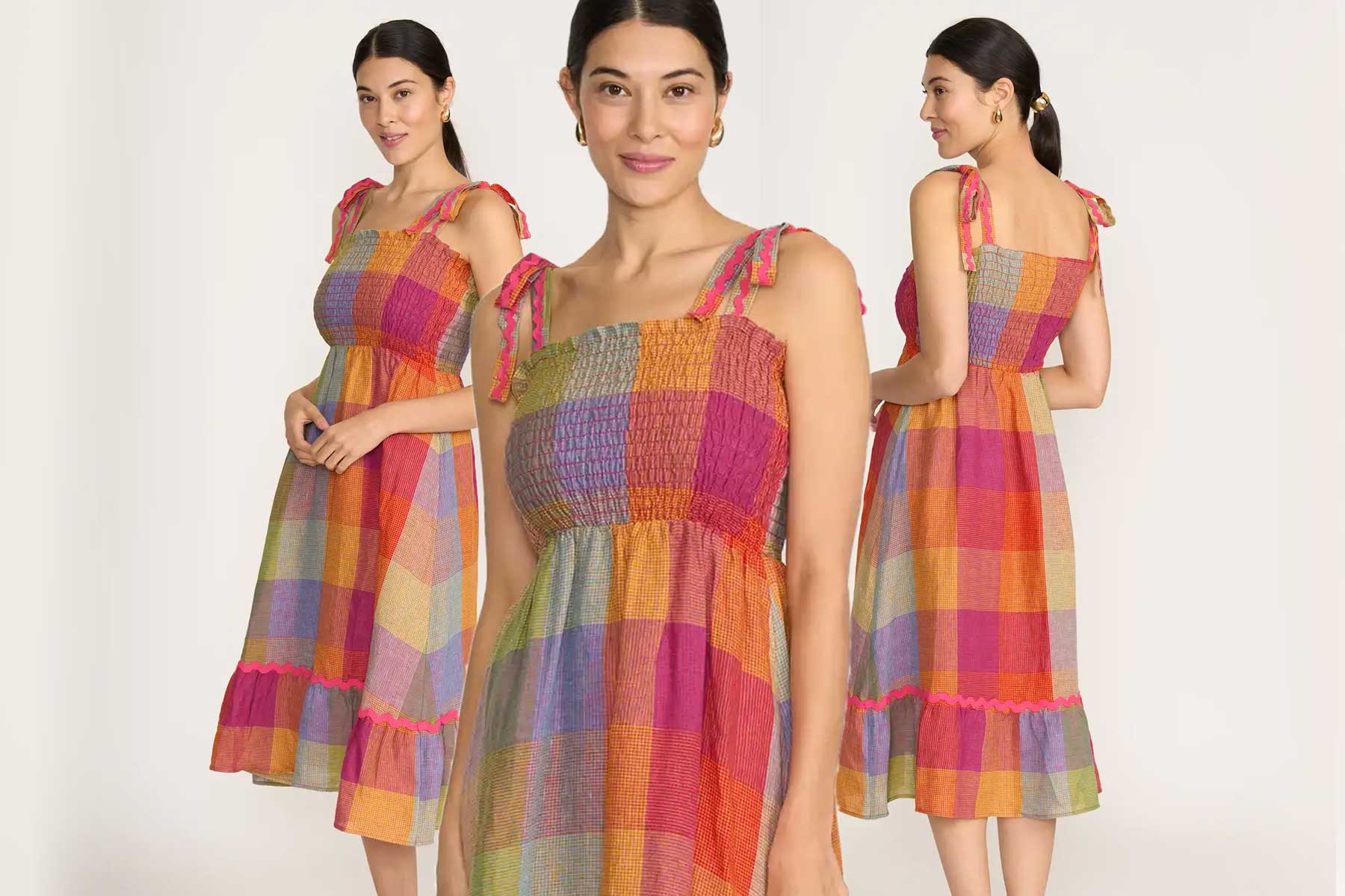 Woman wearing a colorful checkered dress with a plain background
