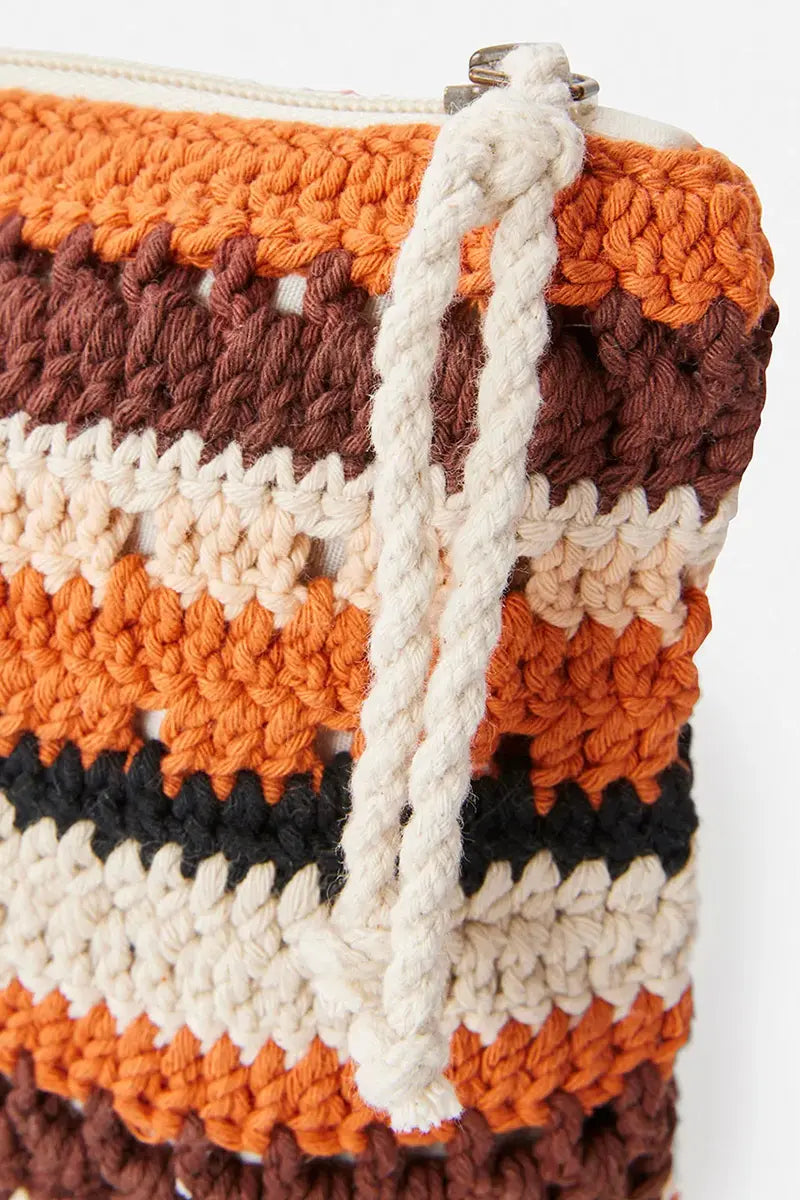detail view of the zip and crochet pattern on the Rip Curl Ellis Crochet Clutch in Cinnamon