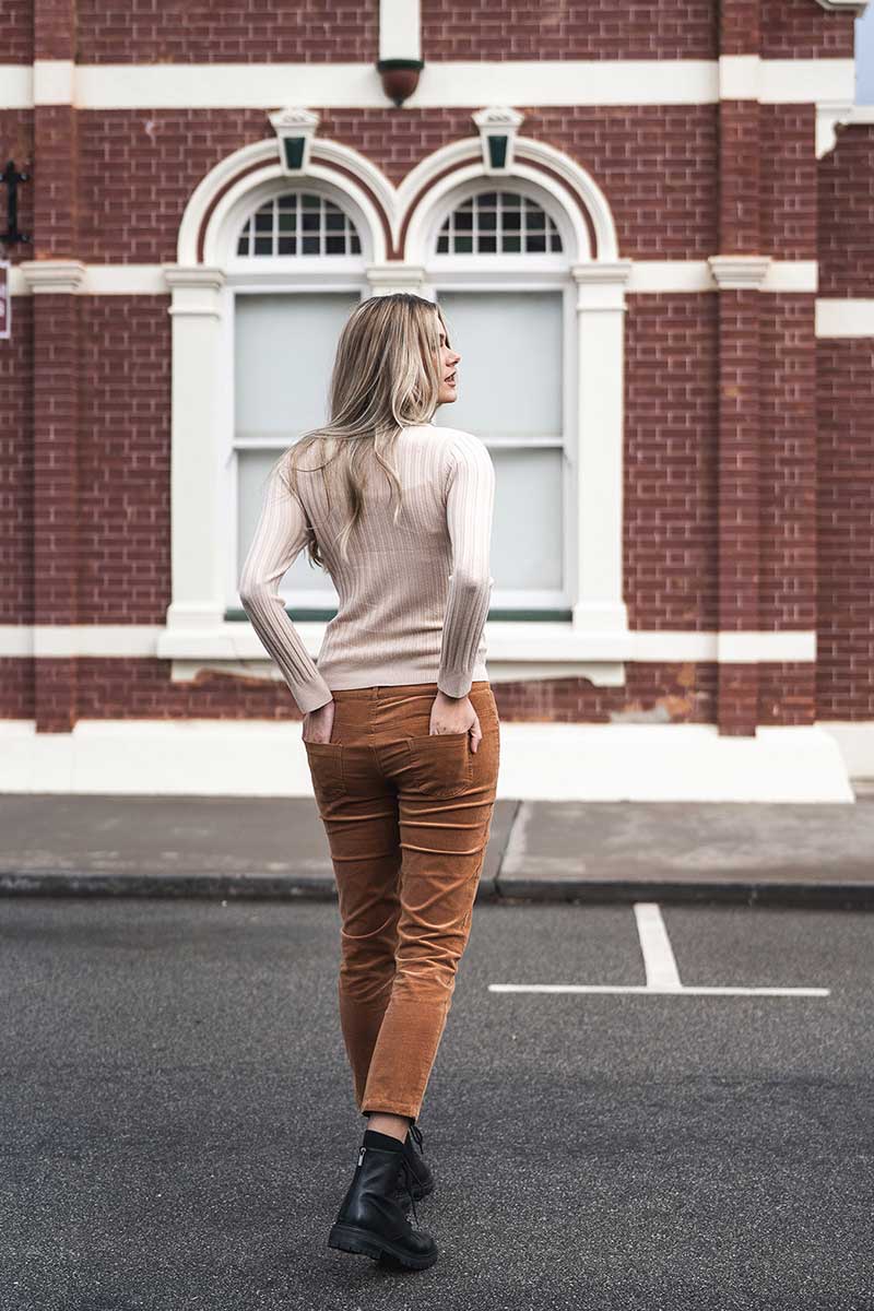 back view of model with Humidity Ines Skivvy in Wheat and cord jeans
