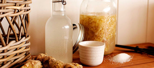 Ginger bug and wild soda starter ingredients on a wooden bench