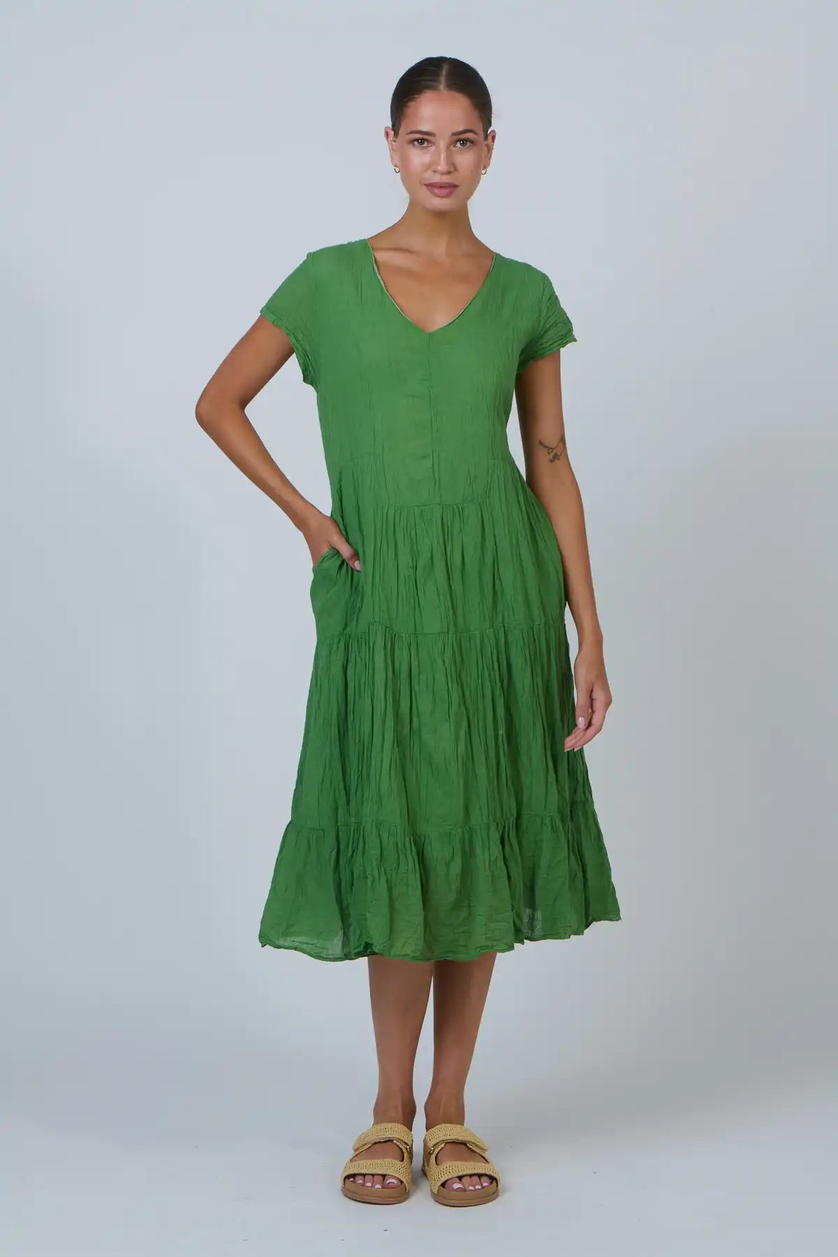 Woman wearing a green dress on a white background