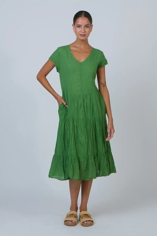 Woman wearing a green dress on a white background
