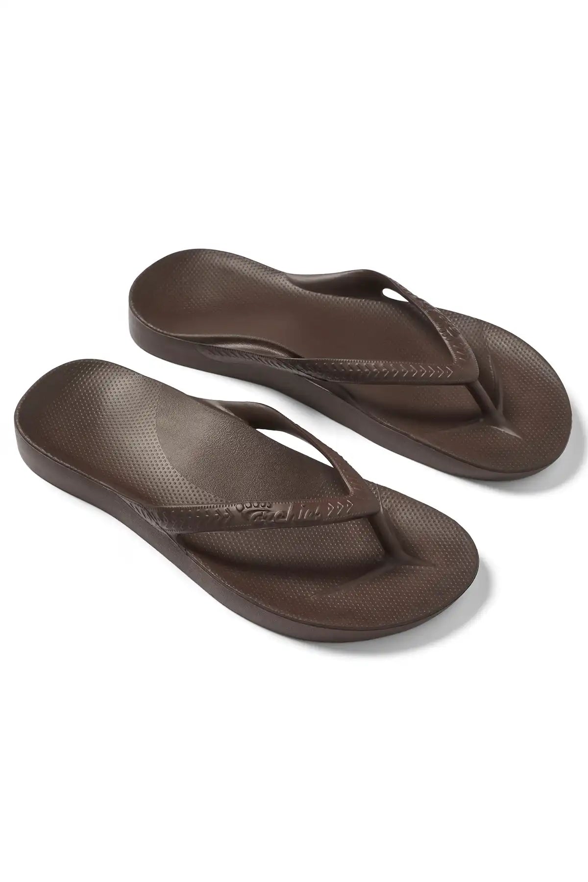 Pair of brown flip-flops on a white background