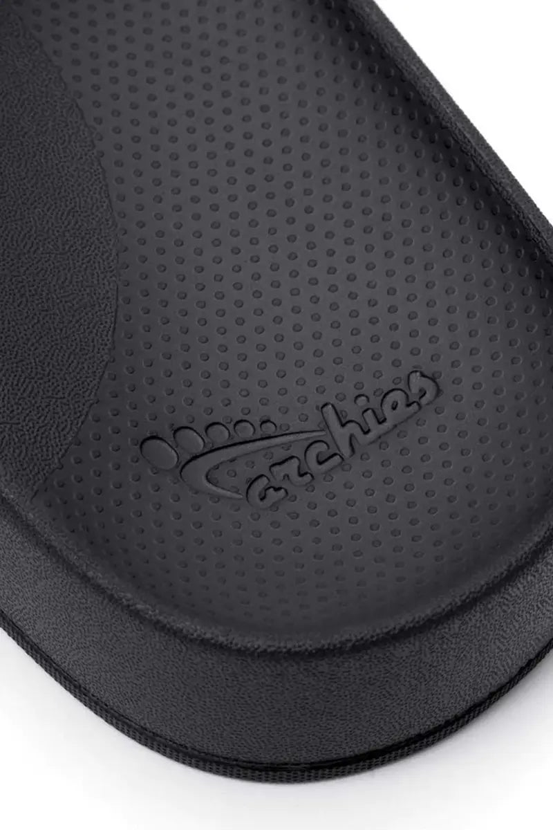 Archies Arch Support Slides in Black close up view of the branding detail on the heal