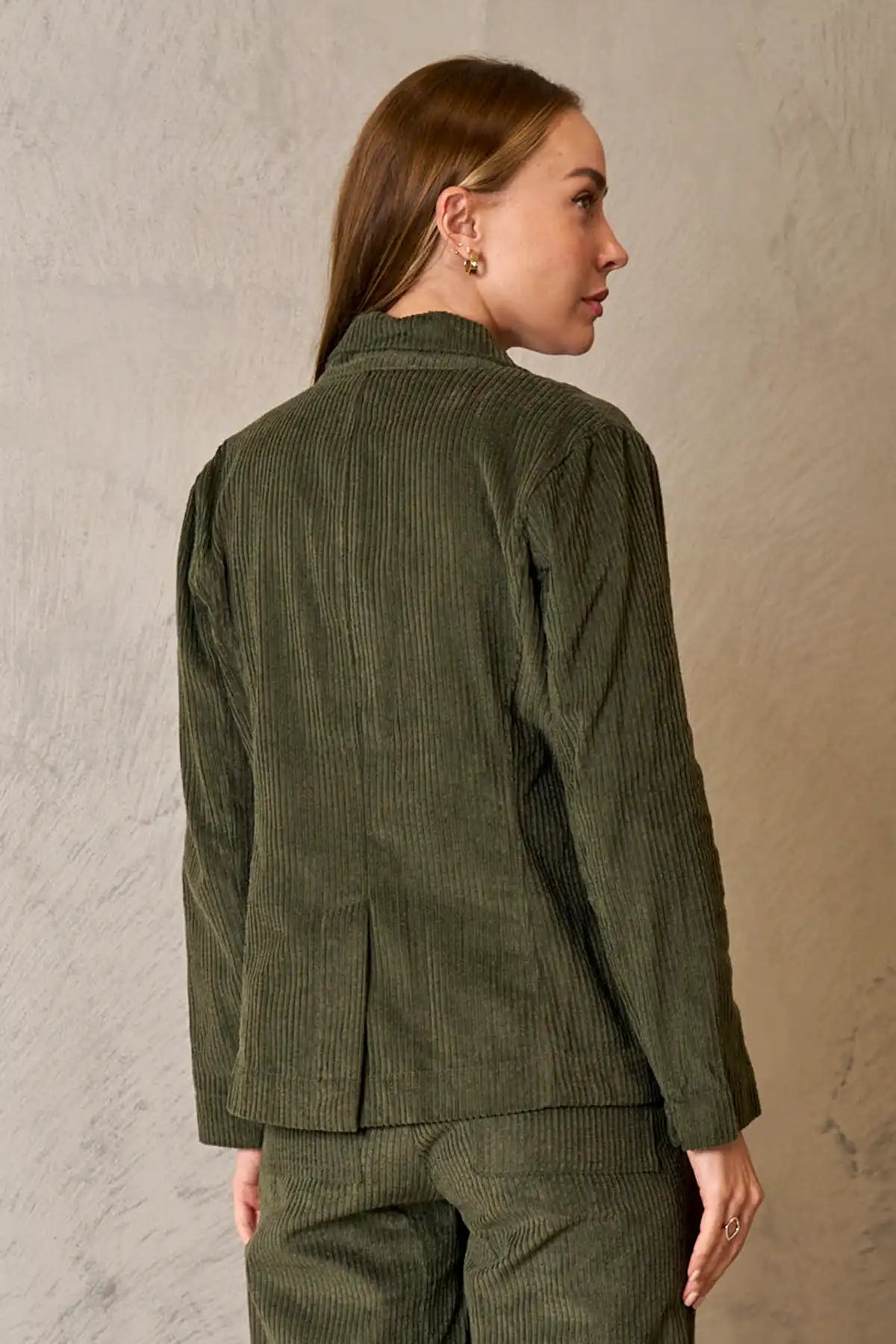 back view of Woman wearing Baltic Corduroy Jacket in Forest against a neutral background