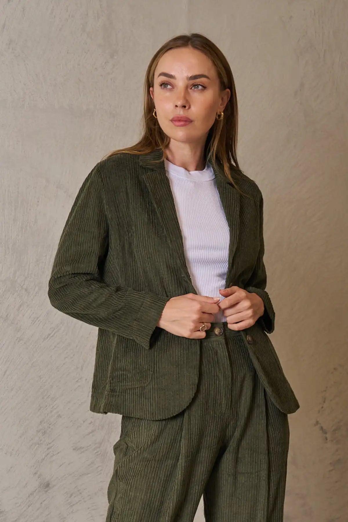 Woman wearing Baltic Corduroy Jacket in Forest against a beige background front view