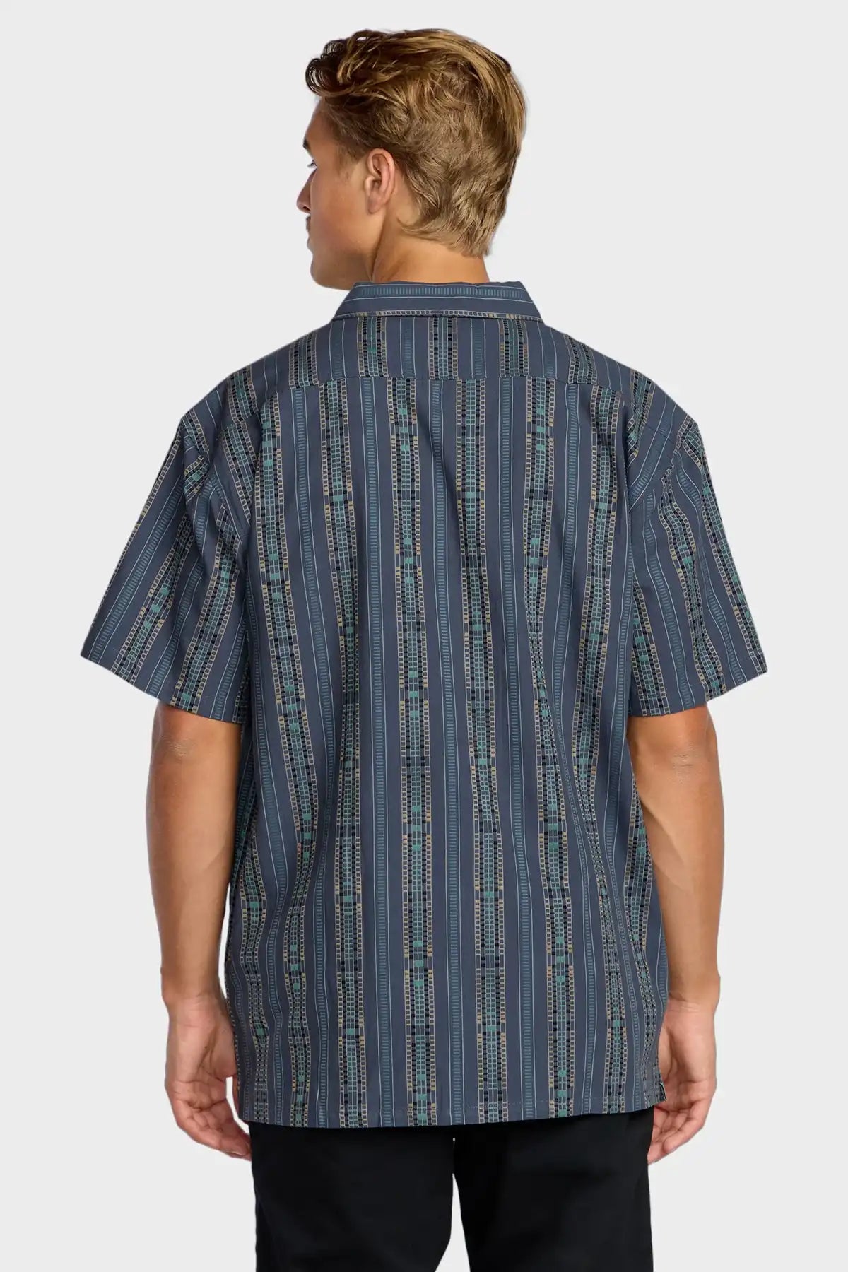 Person wearing a blue patterned Billabong shirt on a white background