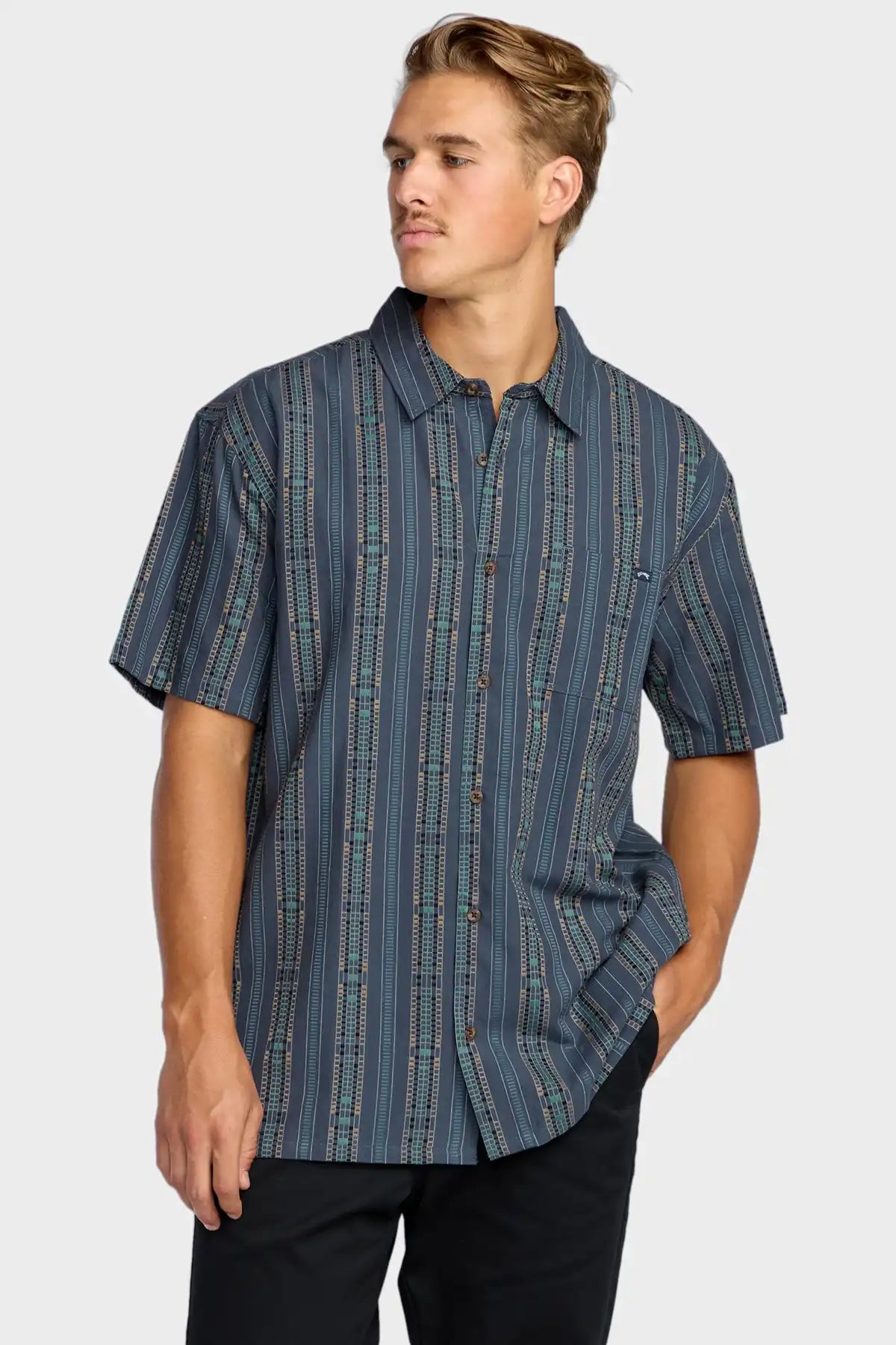 Man wearing a blue Billabong patterned shirt on a white background