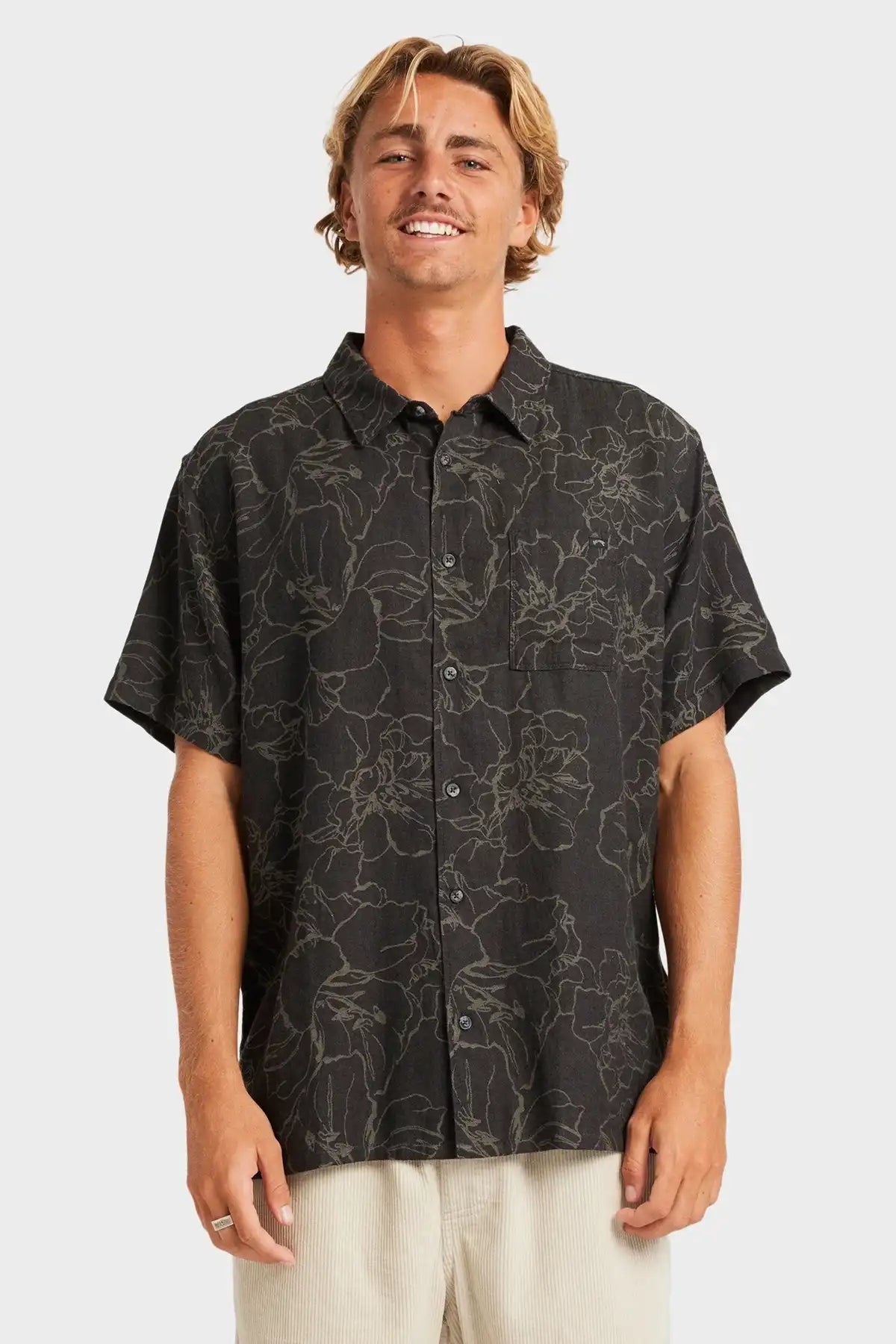 Man wearing a black Billabong patterned shirt on a white background